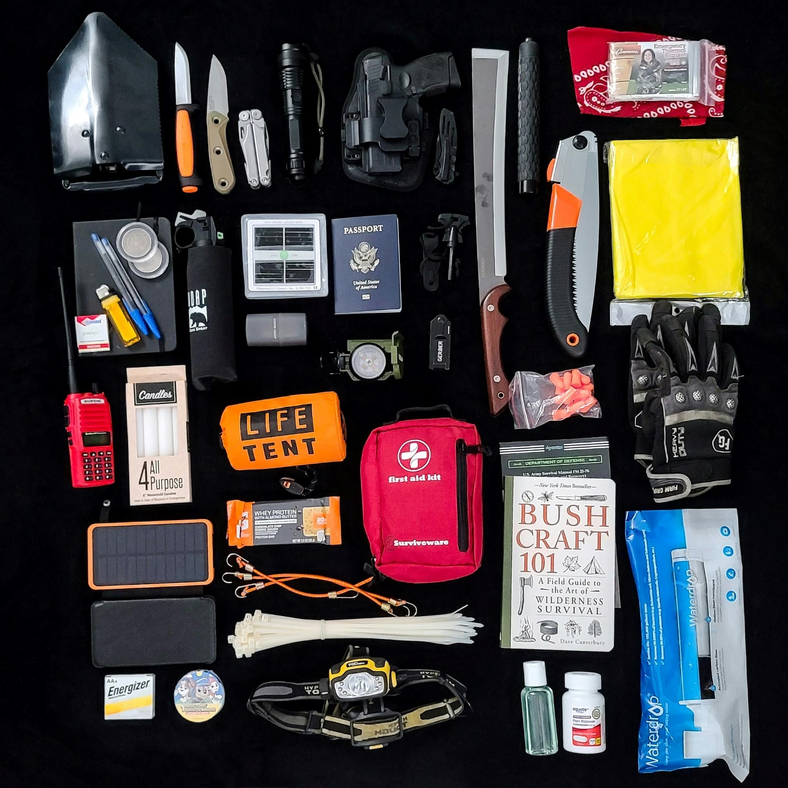 A survival kit displayed on a black surface, showcasing essential tools and supplies for emergency preparedness.