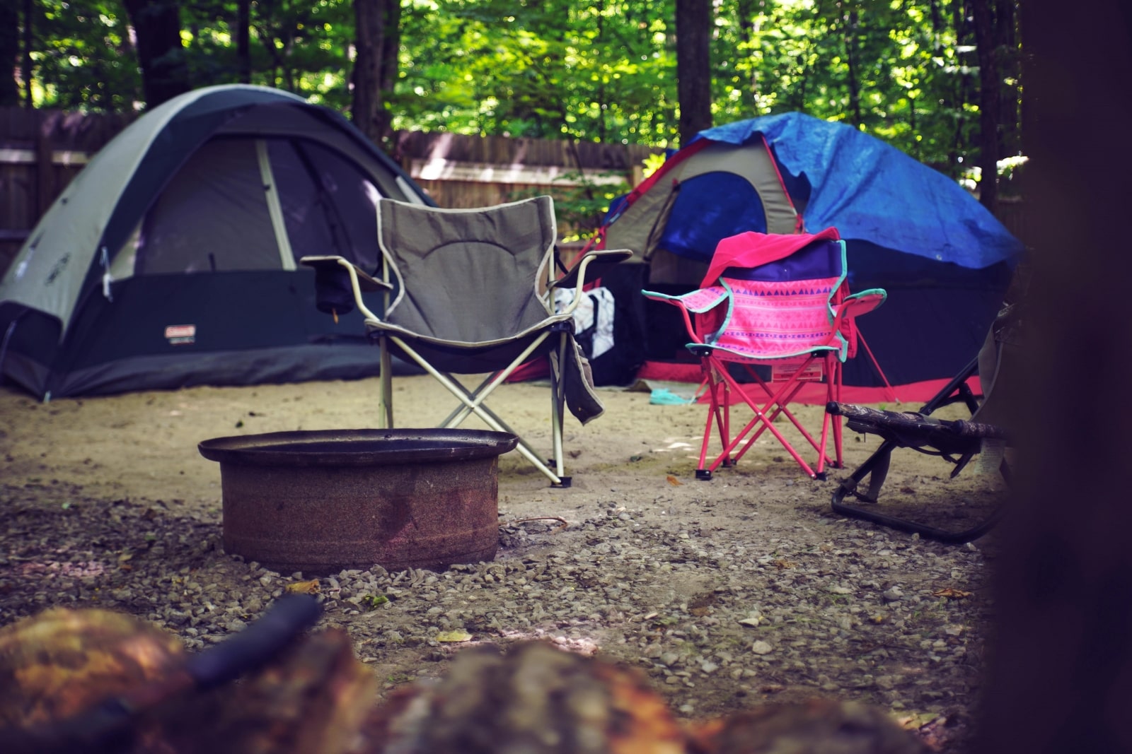 A tent and a chair set up in a serene campground, surrounded by nature and inviting outdoor relaxation.