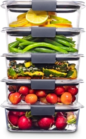 Four colorful plastic containers filled with fresh vegetables and fruits, showcasing a healthy assortment of produce.