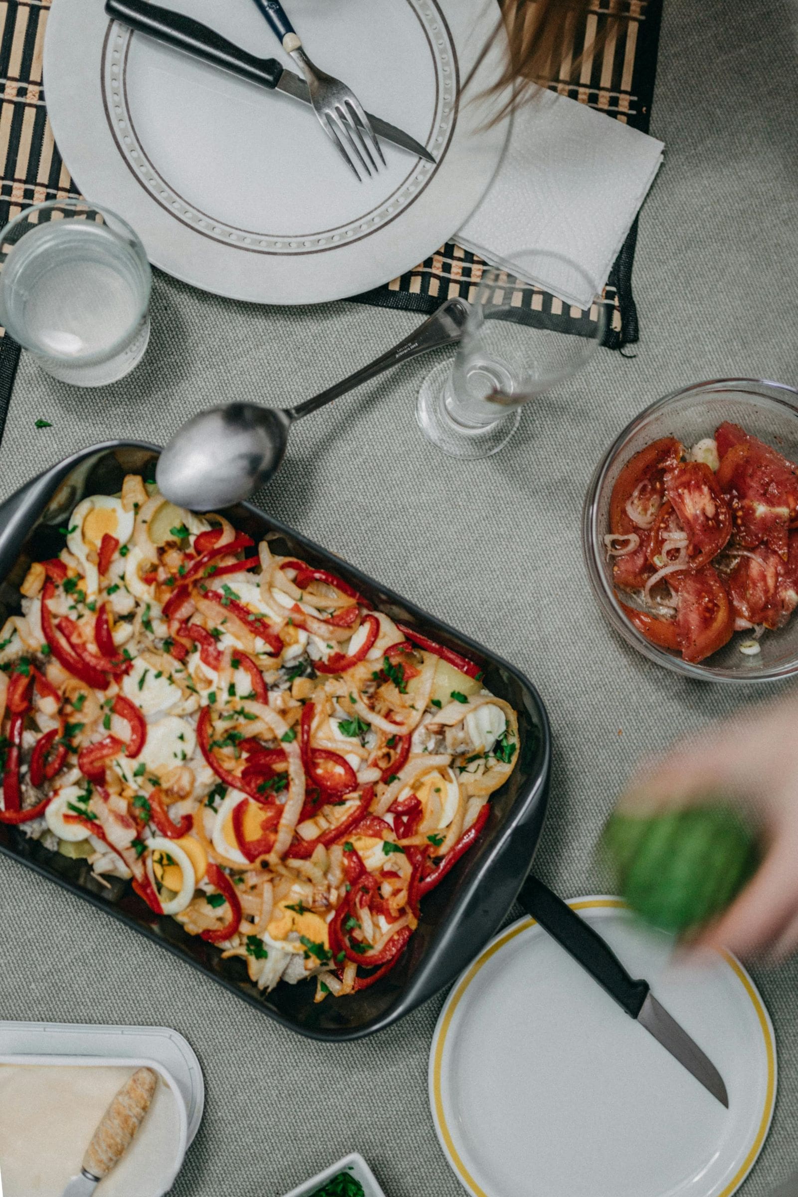 A black pan filled with a colorful assortment of cooked food, showcasing a variety of textures and ingredients.