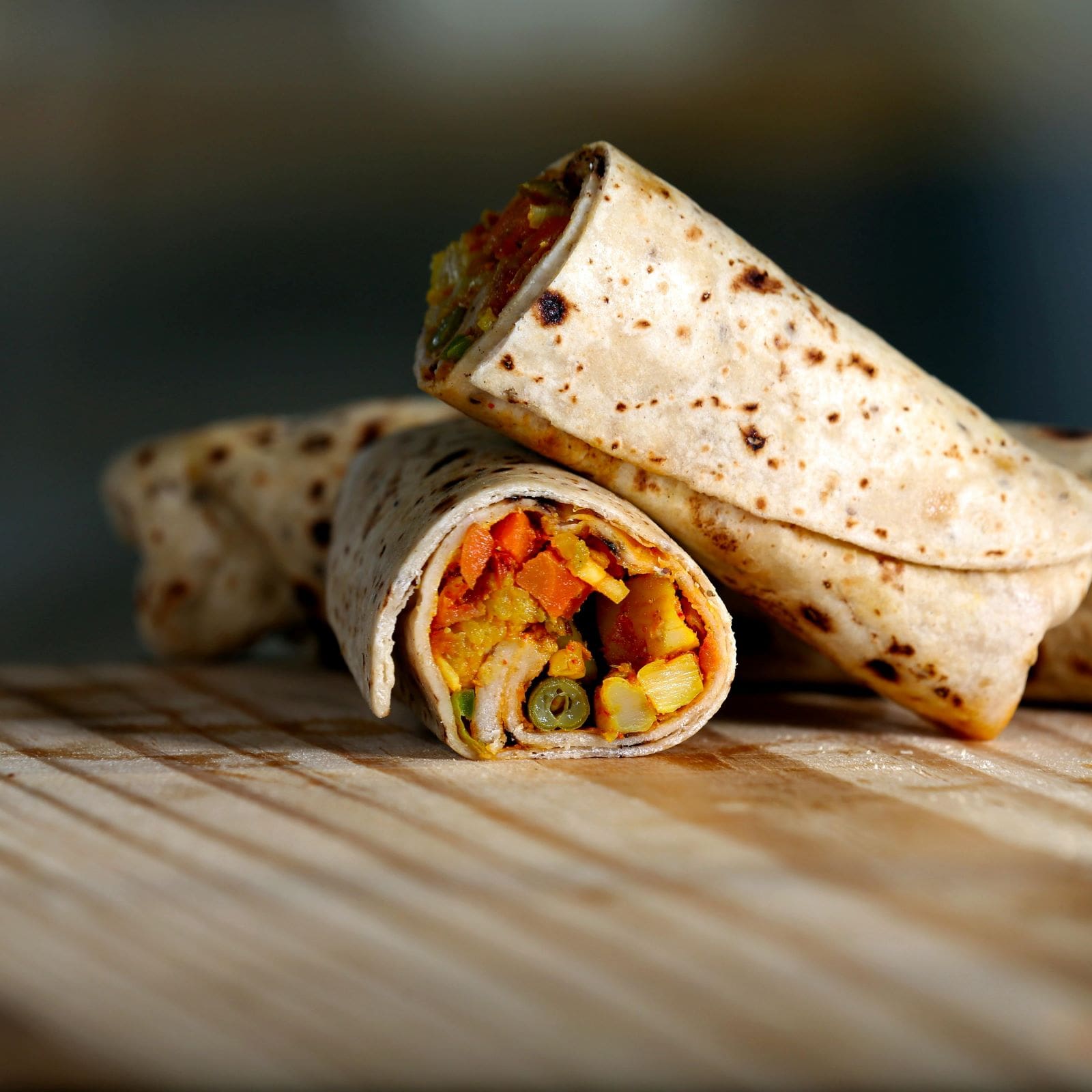 A close-up view of a burrito filled with fresh vegetables, showcasing vibrant colors and textures.