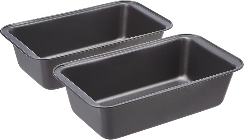 Two rectangular metal pans with handles positioned side by side on a neutral background.