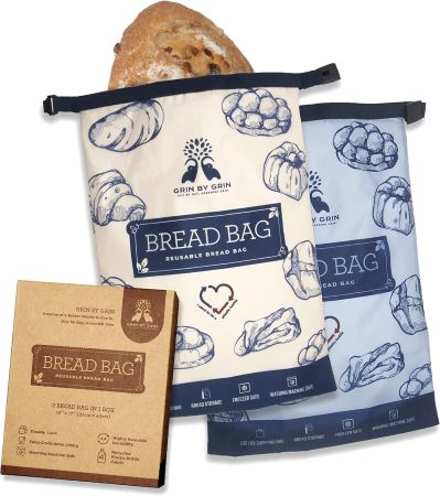 A bag filled with fresh bread alongside a box containing additional bread products.