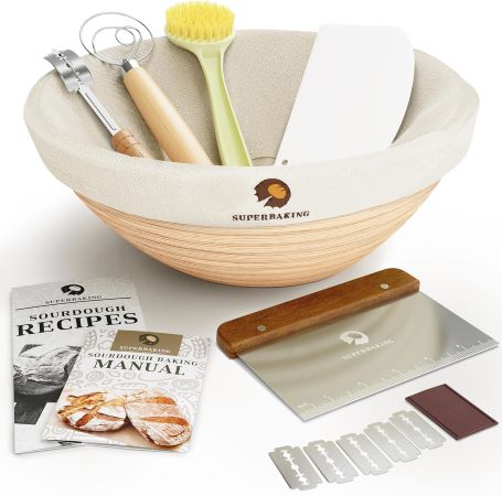 A wooden bowl accompanied by a cutting board, spatula, and various kitchen utensils arranged neatly on a countertop.