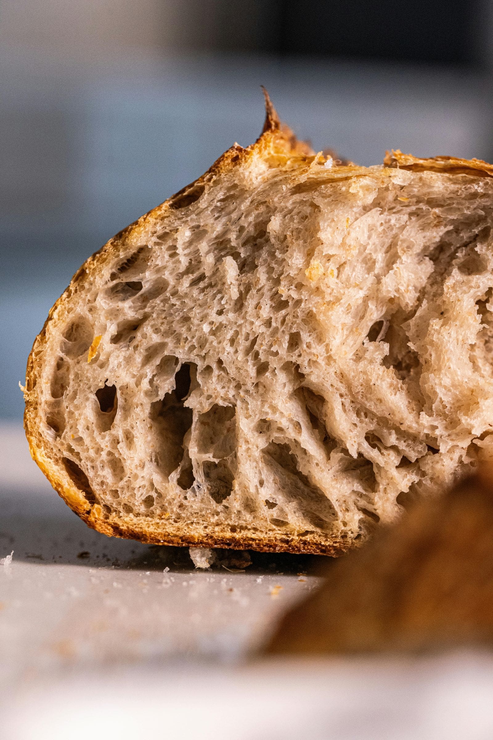 A close-up view of a freshly baked loaf of bread, showcasing its golden crust and soft interior texture.